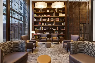 a waiting room with chairs and bookshelves at Tribeca Studio w Tons of light Gym Pool NYC-118 in New York