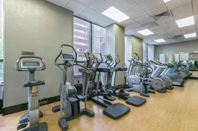 a row of cardio machines in a gym at Tribeca Studio w Pool Roofdeck Gym View NYC-273 in New York