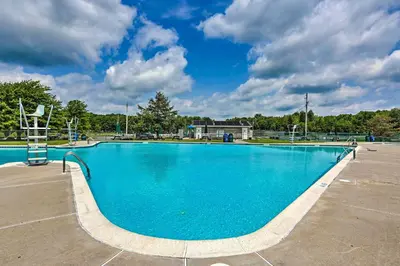 a large blue swimming pool in a parking lot at Pet-Friendly Pocono Lake Cabin with Community Pool! in Pocono Lake