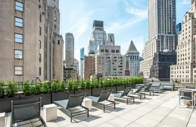 a row of chairs on the roof of a building at FiDi Studio w Gym Lounge Complete Gym NYC-499 in New York