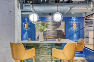 a dining room with blue walls and a table with chairs at Midtown East 1br w doorman nr Grand Central NYC-1170 in New York