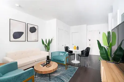 a living room with a couch and chairs and a table at 444-4F Newly renovated 1BR in Midtown West in New York