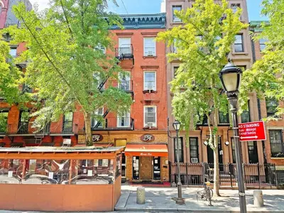 a street light and trees in front of a building at Convenient 2BR - Walking distance to Times Square in New York