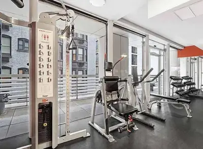 a gym with treadmills and ellipticals in a building at Beautiful 2BD with a Gym near Times Square in New York