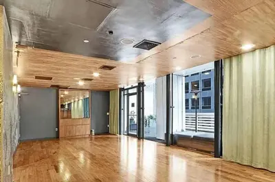 an empty room with a hard wood floor and large windows at Stylish 1BD near Bryant Park with Washer and Dryer in New York
