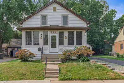 a white house with a front porch and stairs at Spacious Home King Beds Gym Deck Games Parking AC in Narberth