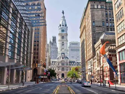 a city street with a building with a clock tower at 503 Bohemian Romance Apartments in center city in Philadelphia