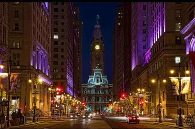 a city street at night with a clock tower at 402 Stylish luxe Apt at center city self check-in in Philadelphia