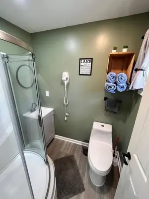 a small bathroom with a toilet and a shower at Wally's Compound in Hawley