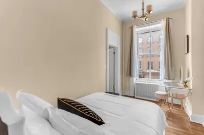 a bedroom with a bed and a desk and a window at Charming 2Bd in Brooklyn Heights in Brooklyn