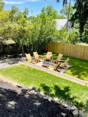 a backyard with chairs and a fire pit in the grass at Cozy Dark & Moody Home New Reno 10 mins to Lanc in Mountville