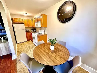 a kitchen with a table and a clock on the wall at Lennox C407 Cozy and Spacious Studio1br Apt in Philadelphia