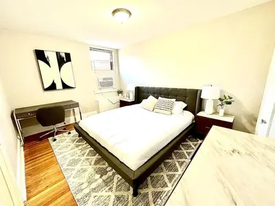a bedroom with a bed and a chair in it at Lennox C303 Peaceful, Perfect Private Studio1br in Philadelphia