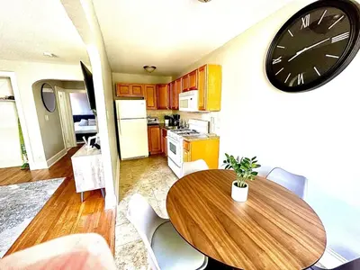 a kitchen with a table and a clock on the wall at Lennox C303 Peaceful, Perfect Private Studio1br in Philadelphia