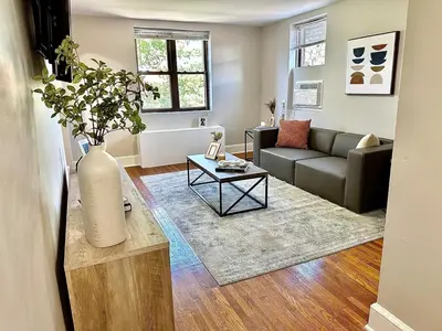 a living room with a couch and a vase on a table at Lennox C304 Peaceful & Perfect Private 1-br in Philadelphia