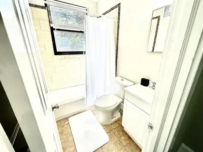 a bathroom with a toilet and a sink and a window at Lennox C304 Peaceful & Perfect Private 1-br in Philadelphia