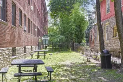 a group of picnic tables next to a brick building at Lennox C409 Peaceful & Perfect Private 1-Br in Philadelphia