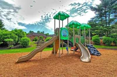 a playground with slides and umbrellas in a park at pb 1112 Furnished 2br with Parking, gym, in Newark