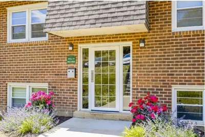 a brick house with white doors and flowers at pb 1112 Furnished 2br with Parking, gym, in Newark