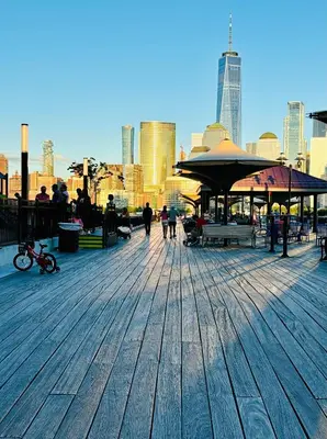 a boardwalk with people walking around in a city at Iron Bound Gem in Newark