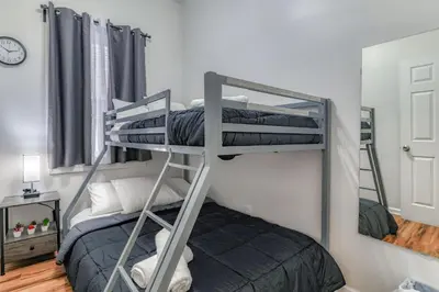 a couple of bunk beds in a room at Gorgeous Duplex with parking by JSQ in Jersey City