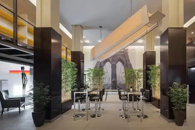 a lobby with tables and chairs and a building at 73-519 New Studio UWS Doorman Gym in New York