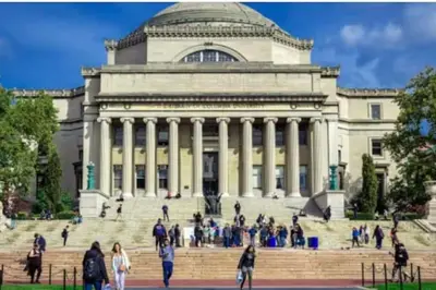 a building with a bunch of people walking in front of it at Newly Renovated 3BR Oasis Walk to Columbia Uni in New York