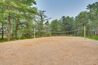 a volleyball net in the middle of a dirt field at Mango Mountain House Pocono in Albrightsville