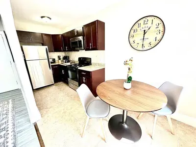 a kitchen with a table and a clock on the wall at Lennox B401 Peaceful & Perfect Studio Apt in Philadelphia