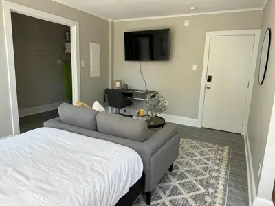 a bedroom with a bed and a couch and a tv at Lennox B401 Peaceful & Perfect Studio Apt in Philadelphia