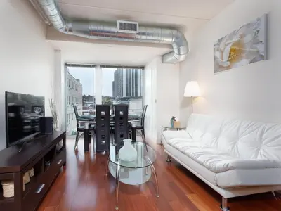 a living room with a white couch and a table at Pet Friendly 2 Bedroom and 2 Bathroom Apartment near Rittenhouse apts in Philadelphia