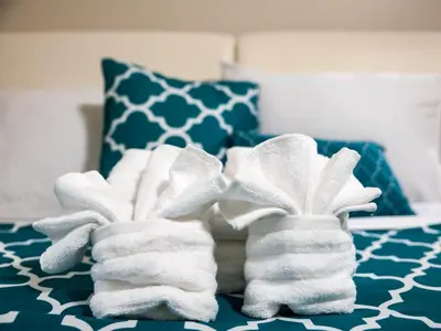 two towels sitting on top of a bed at Cozy Fully Furnished 2 Bedroom 2 Bathroom Apartment apts in Philadelphia
