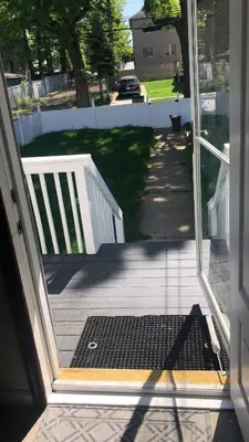 an open door to a porch with a gate at cozy room with private bathroom in Arlington