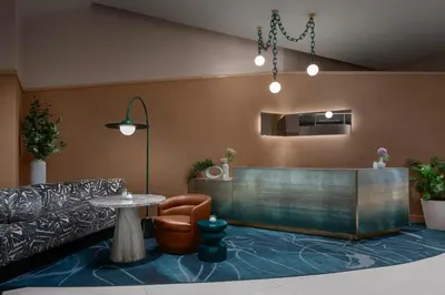 a waiting room with a table and a chair at Financial District 1br w WD gym elevator NYC-1362 in New York