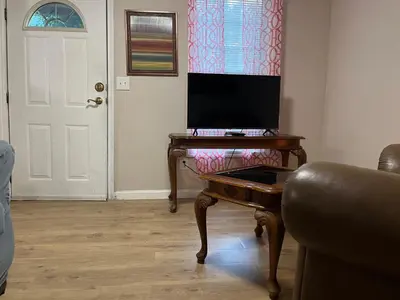 a living room with a desk with a computer on it at Cozy Apt near BU, Lourdes, UHS in Johnson City