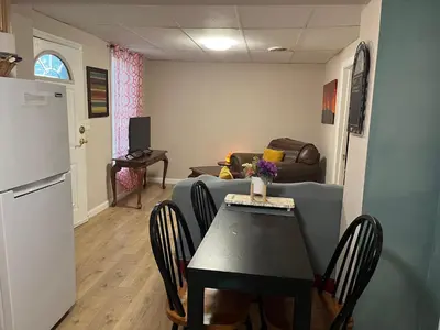 a living room with a table and a couch at Cozy Apt near BU, Lourdes, UHS in Johnson City
