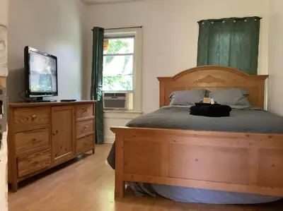 a bedroom with a bed with a television and a dresser at Spacious 3 bed by Wilson, Lourdes Hospitals near Vestal in Johnson City