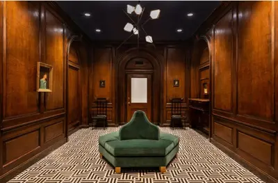a green chair in a room with wooden walls at FiDi 1br w fitness center nr freedom tower NYC-1340 in New York