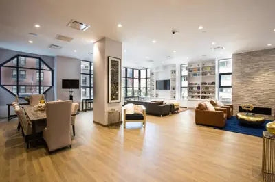 a living room with a table and chairs at Midtown 1br w doorman wd nr Times Square NYC-1351 in New York