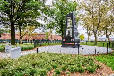 a sculpture in a park with trees and a fence at Financial District studio w gym doorman NYC-1289 in New York