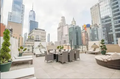 a rooftop patio with a view of a city at Spacious Luxury 2BD Downtown Gym W/D Doorman in New York