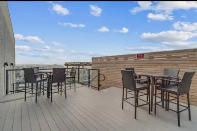 a group of chairs and tables on a balcony at XL Studio - Premier Studio with Gym Access in Philadelphia