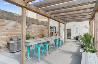 a patio with a bar and stools at XL Studio - Stylish Studio with Rooftop Pool in Philadelphia