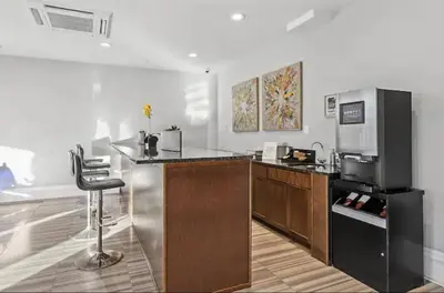 a kitchen with a counter and a bar with a refrigerator at XL Studio - Luxury Studio Near Center City in Philadelphia