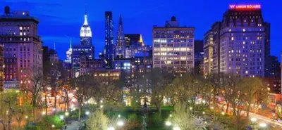 a view of a city at night with lights at Chic One Bedroom Retreat in Downtown Manhattan in New York