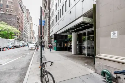 a bike parked on a sidewalk next to a street at Midtown West 1br w doorman nr rockefeller center NYC-1394 in New York