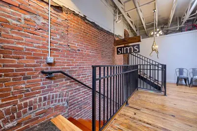 a brick wall with a staircase in a room at Sweet Lancaster Apt. A in Lancaster