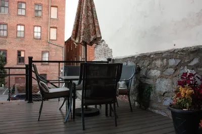 a patio with chairs and a table and an umbrella at Sweet Lancaster Apt. A in Lancaster