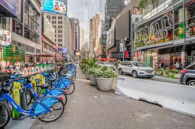 a row of blue bikes parked on a city street at Theater District Studio w Indoor pool NYC-142 in New York