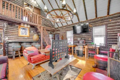 a living room with wooden walls and a fireplace and a television at Easy Interstate Access Original Poconos Log Cabin in Blakeslee